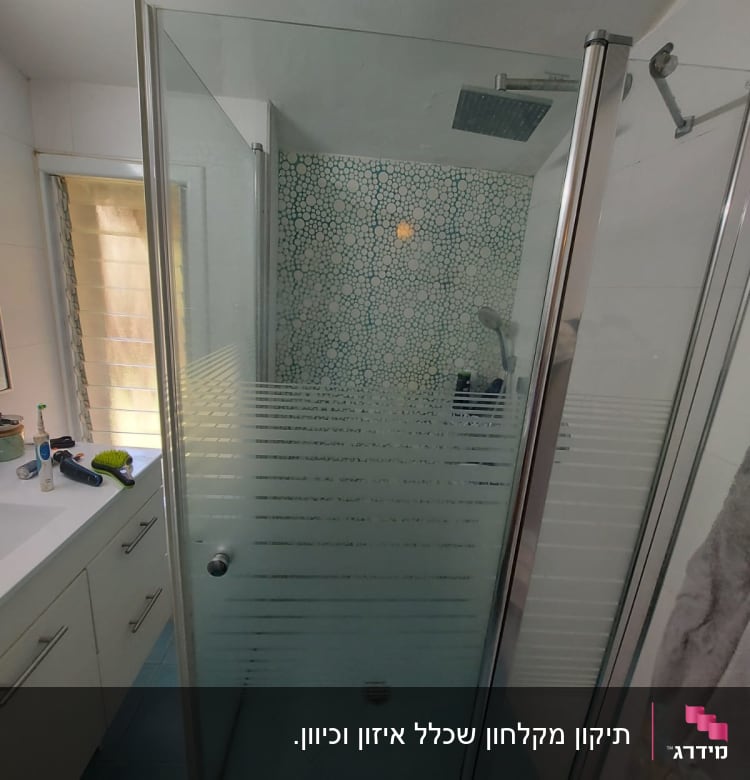 מקלחון זכוכית עם ראש מקלחת מרובע וקיר אריחים מעוצב